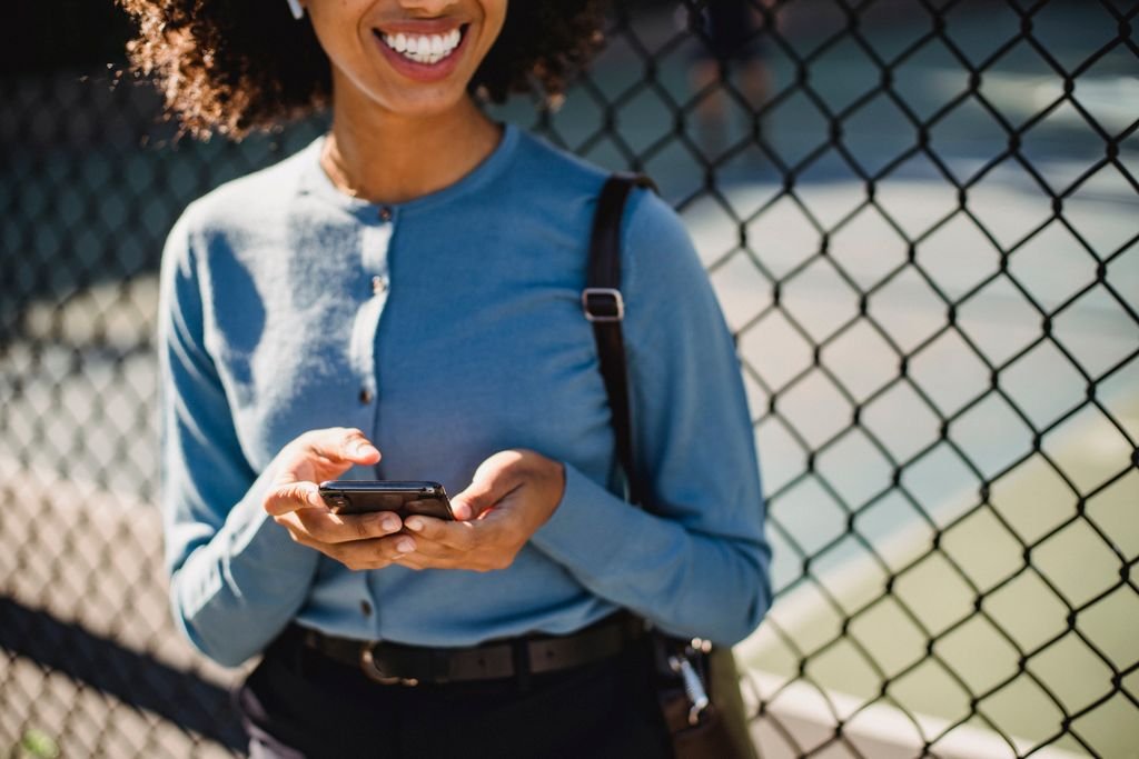 Woman listening to a WhatsApp voice message on her phone