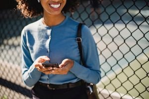 Woman listening to a WhatsApp voice message on her phone